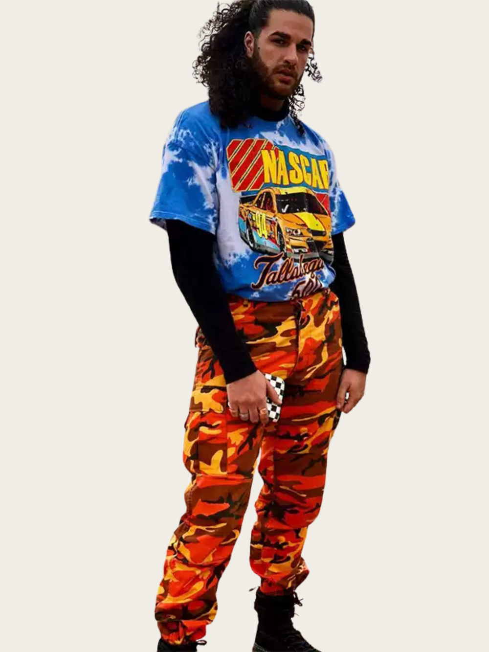 Person wearing a blue tie-dye shirt with NASCAR graphics and orange camouflage pants on a white background