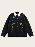 Black jacket with floral embroidery on a beige background