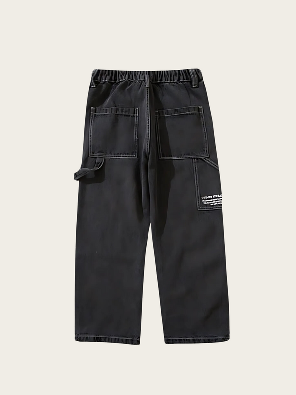 Black pants with multiple pockets on a light gray background