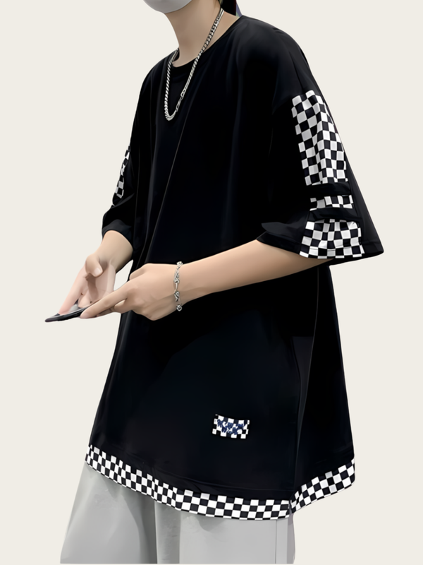 Person wearing a black outfit with checkered sleeves and hem on a white background