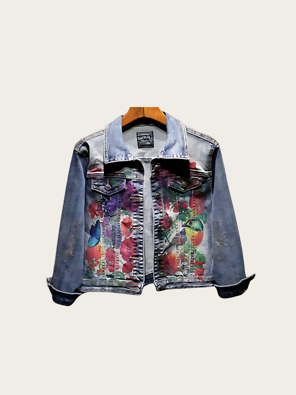 Denim jacket with floral patterns on a light gray background