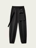 Black pants with suspenders on a light gray background