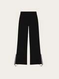 Black pants with white trim on a light gray background