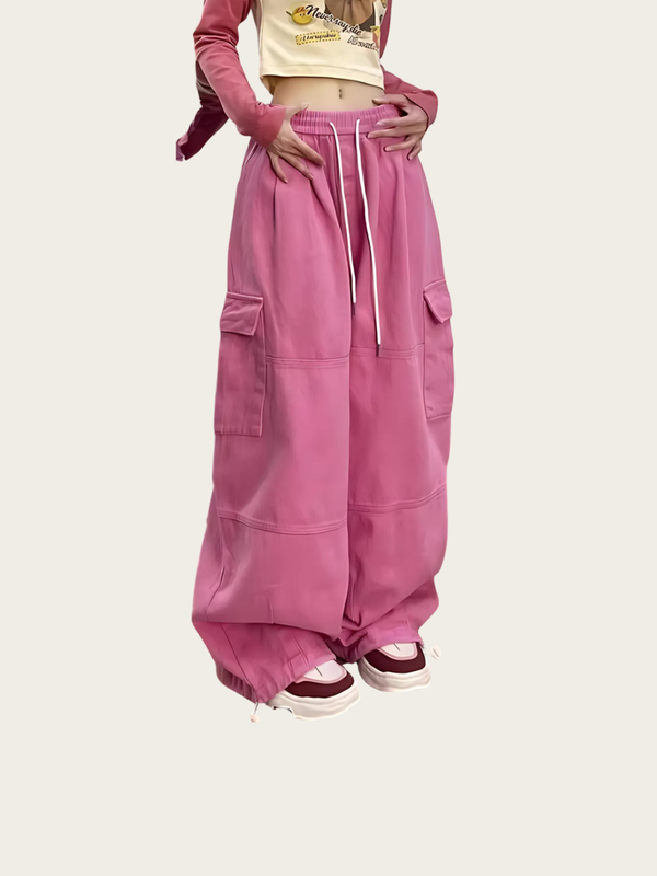 Person wearing pink cargo pants on a white background