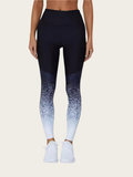 Person wearing black and blue gradient leggings on a white background