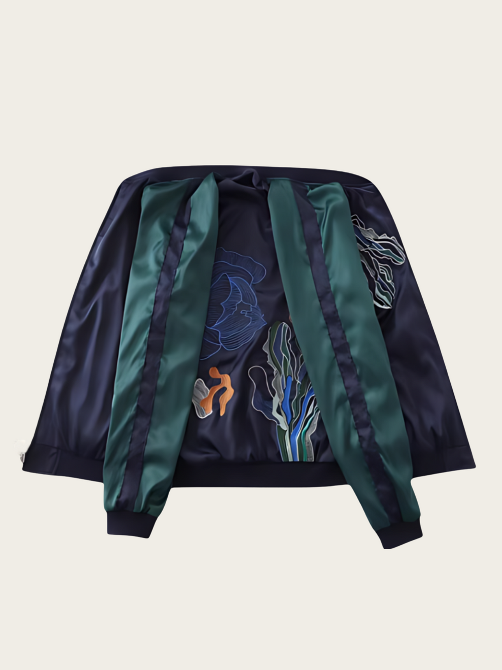 Navy and green jacket with embroidered designs on a beige background
