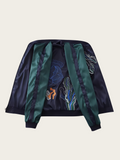Navy and green jacket with embroidered designs on a beige background