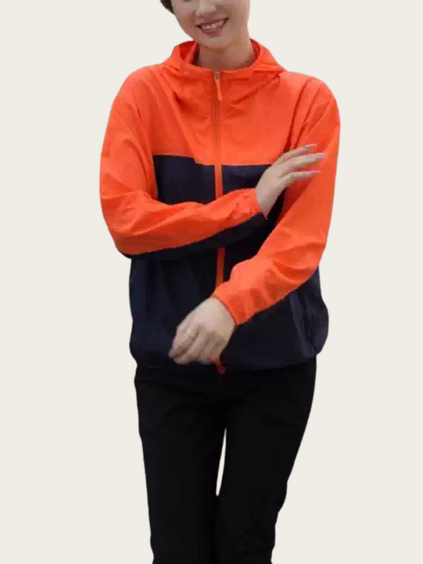 Person wearing an orange and navy tracksuit on a plain background