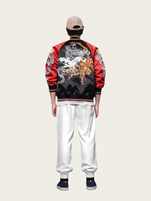 Person wearing a red and black jacket with intricate designs on a plain background
