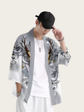 Person wearing a gray kimono-style jacket with intricate designs on a white background