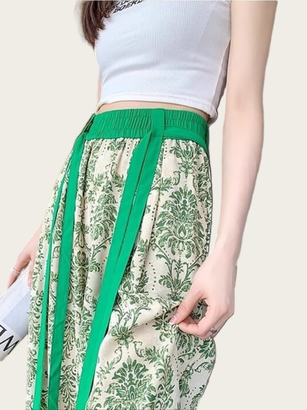 Green and white floral pants with a plain background