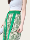 Green and white floral pants with a plain background