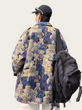 Person wearing a colorful teddy bear patterned coat with a black backpack on a white background