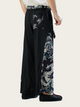 Black wide-leg pants with floral patterns on a white background