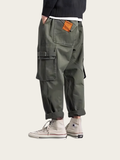 Person wearing green cargo pants with a white background