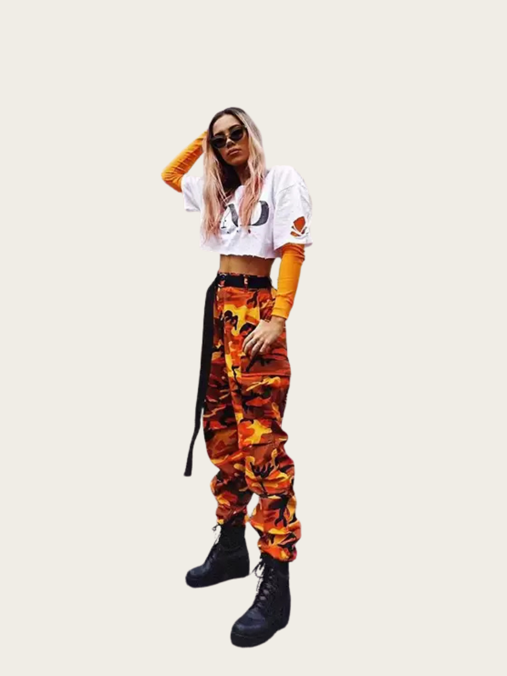 Person wearing a white crop top with 'AD' logo, orange sleeves, and camouflage pants on a white background