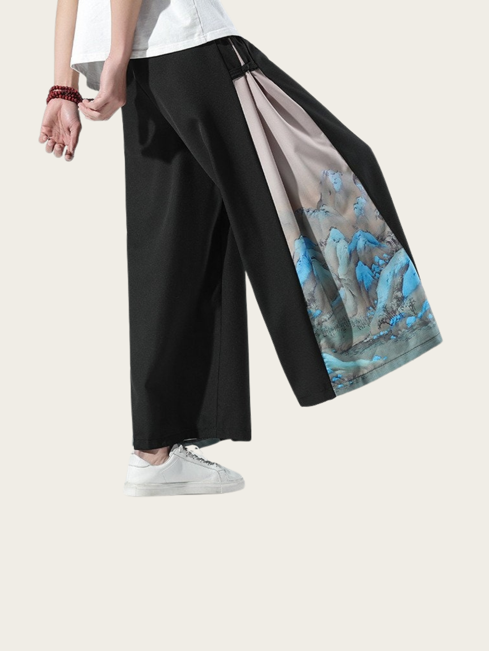 Person wearing black wide-leg pants with a colorful inner lining on a white background