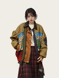 Person wearing a colorful jacket with a patterned design on a plain background
