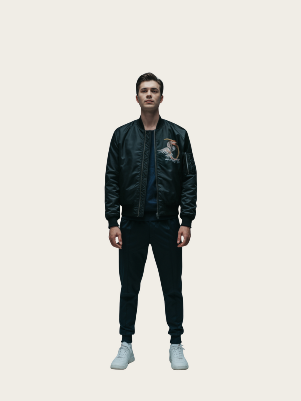 Person wearing a black leather jacket and pants on a light gray background