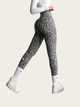 Person wearing gray leopard print leggings on a white background
