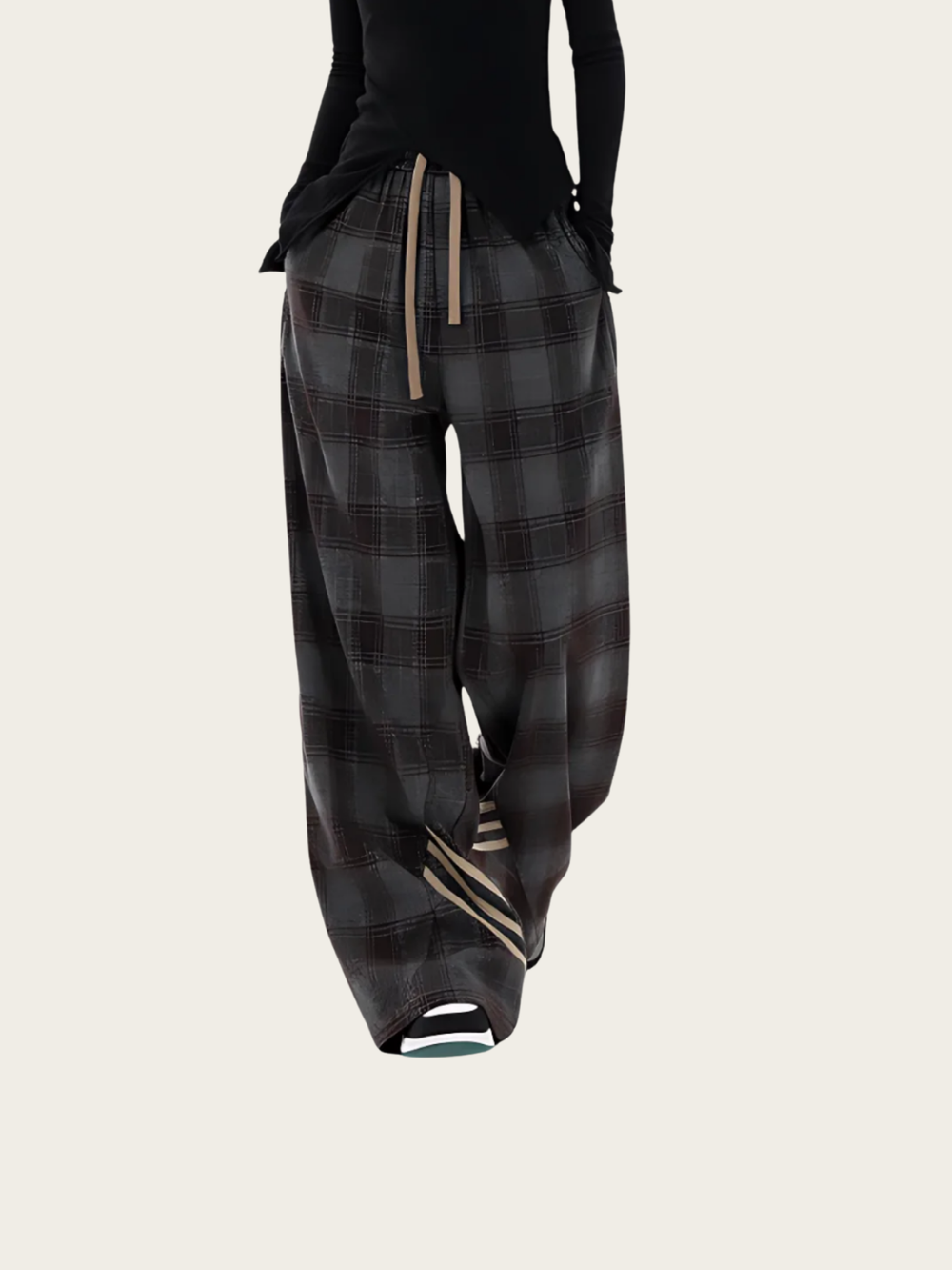 Plaid pants worn by a person on a light gray background