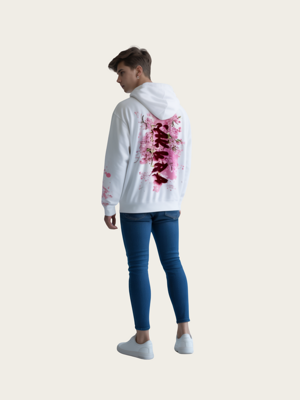 Person wearing a white hoodie with pink floral designs on a plain background