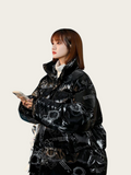 Person wearing a black reflective jacket with patterns on a white background