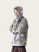 Person wearing a gray denim jacket with patches on a white background