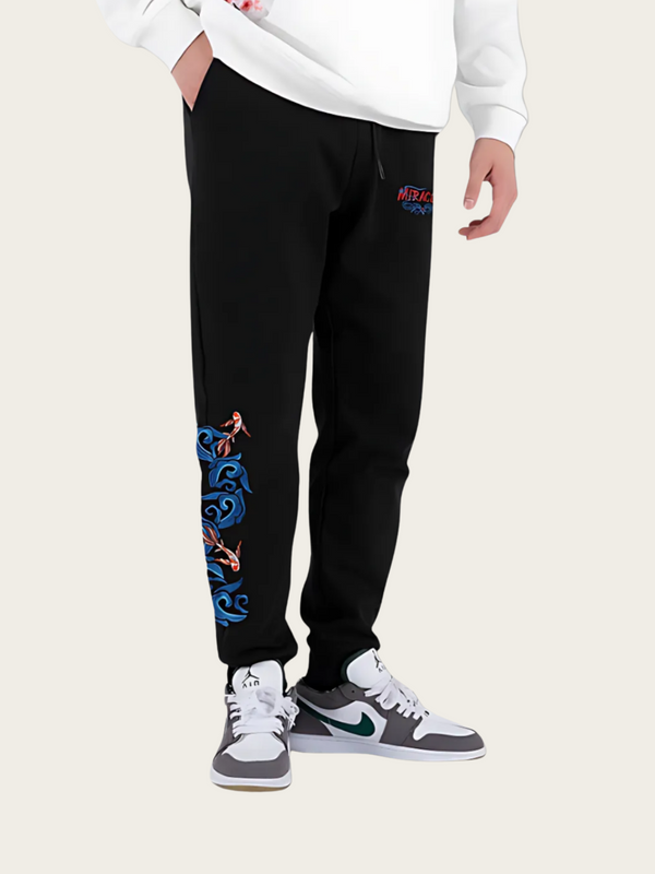 Person wearing black sweatpants with colorful designs on a white background