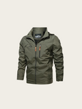 Green jacket with orange zipper on a beige background