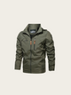 Green jacket with orange zipper on a beige background