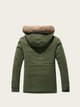 Green parka jacket with fur-lined hood on a beige background