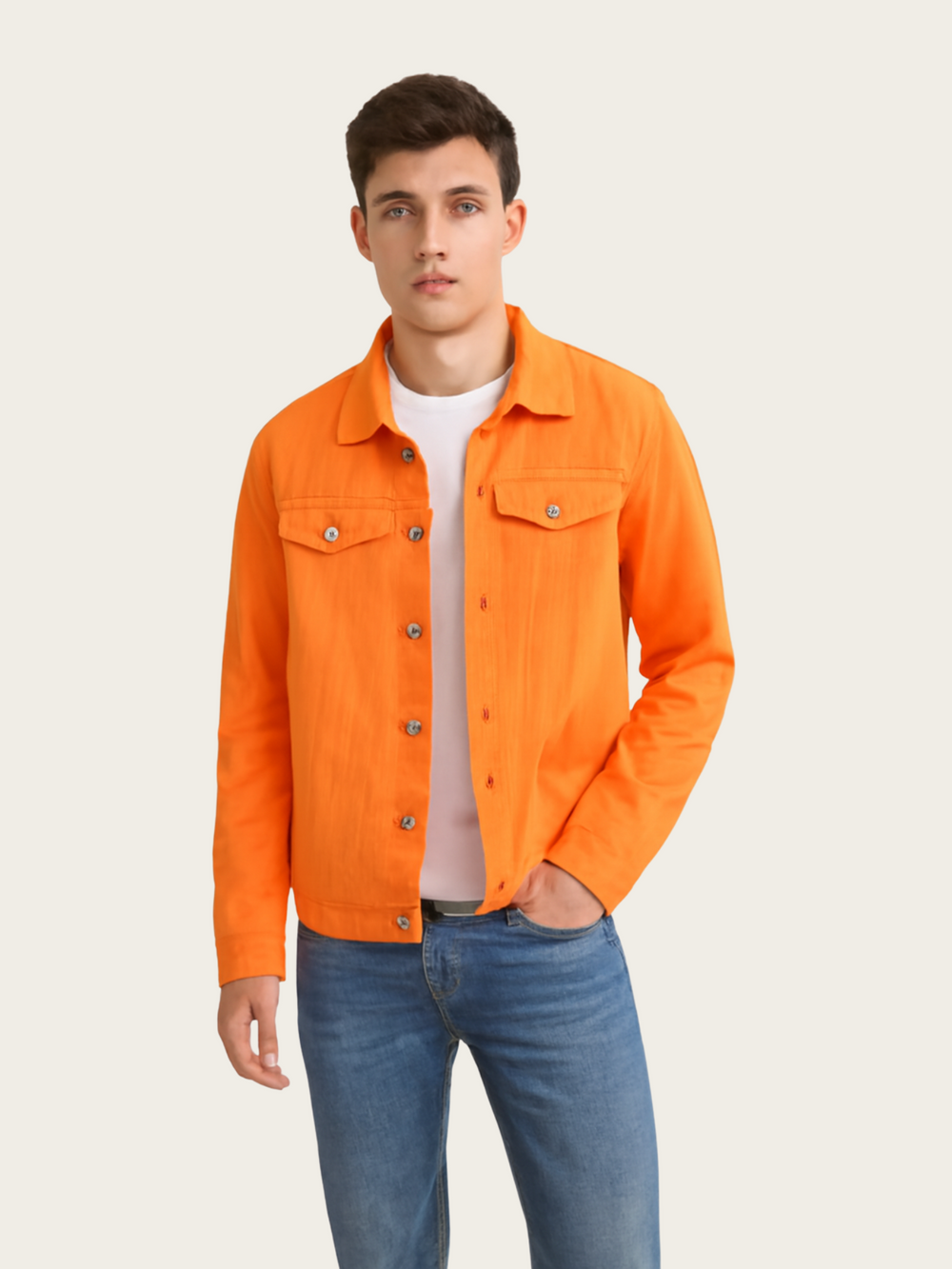 Man wearing an orange jacket and blue jeans on a plain background