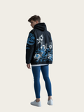 Person wearing a black hoodie with blue dragon design on the back against a white background