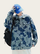 Person wearing a blue camouflage jacket and blue cap on a white background