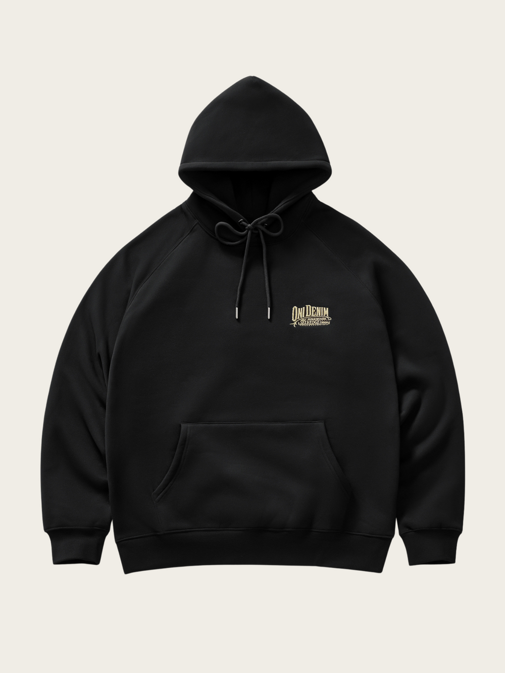 Black hoodie with a small logo on the chest against a light beige background