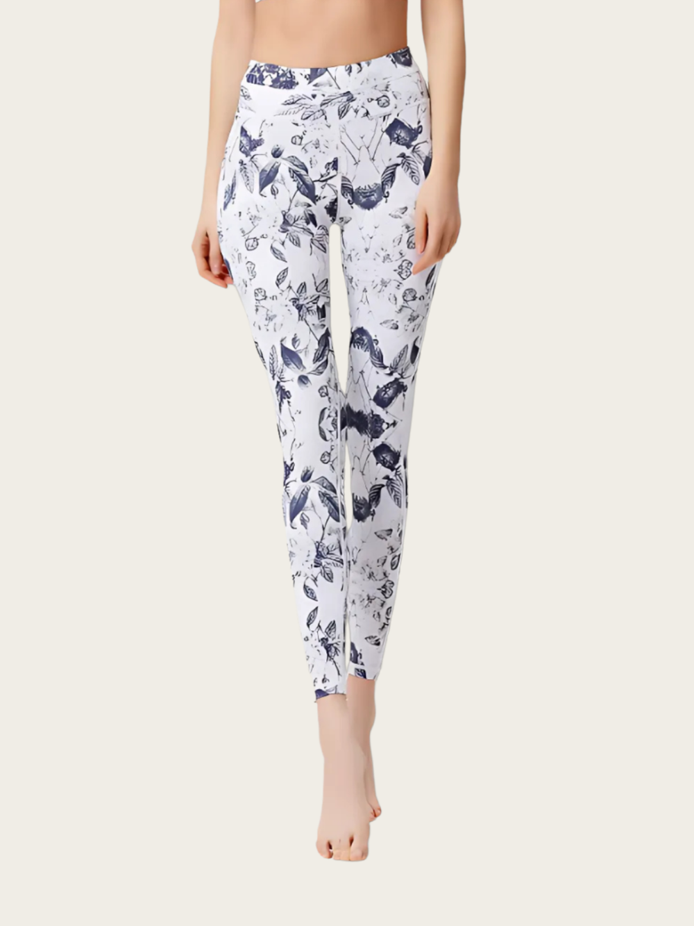 Person wearing white leggings with blue floral pattern on a white background
