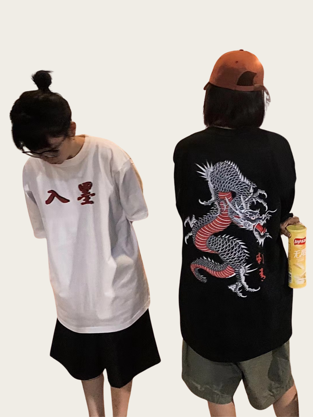 Two people wearing t-shirts with Chinese characters and a dragon design.