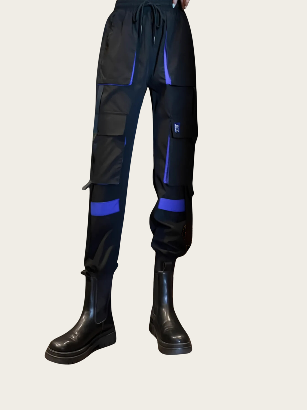 Black and blue cargo pants with black boots on a light gray background