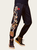 Black pants with intricate floral embroidery on a white background
