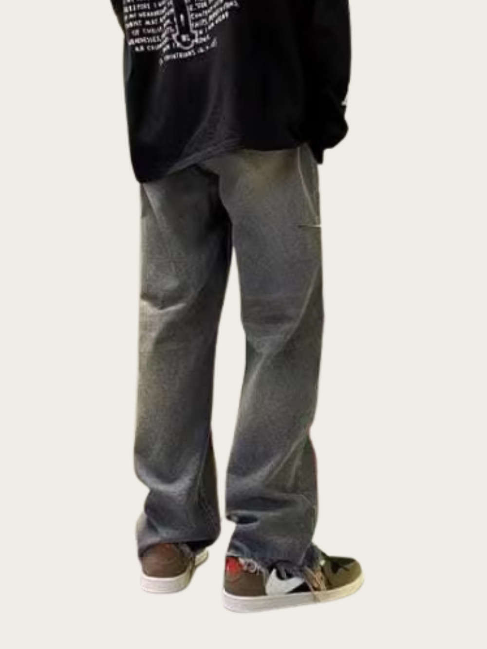 Person wearing gray pants and a black hoodie on a white background