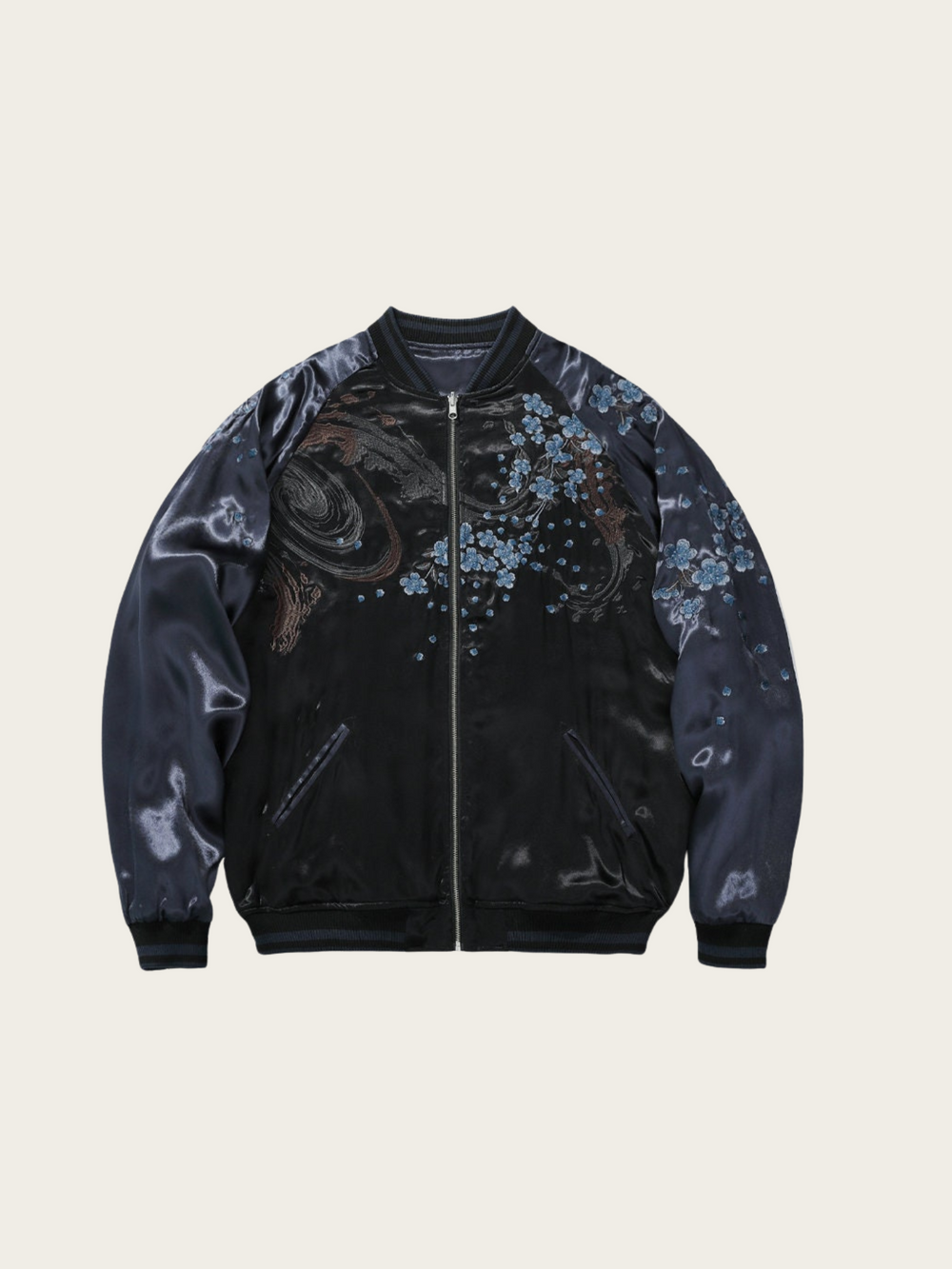 Black bomber jacket with floral patterns on a beige background