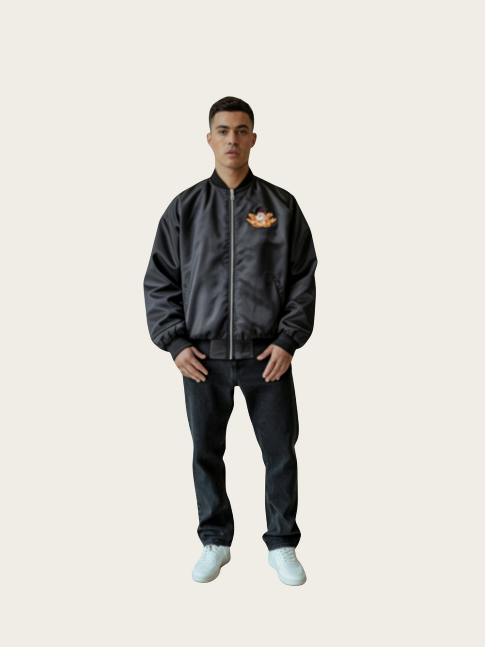 Person wearing a dark jacket with a logo on a plain background