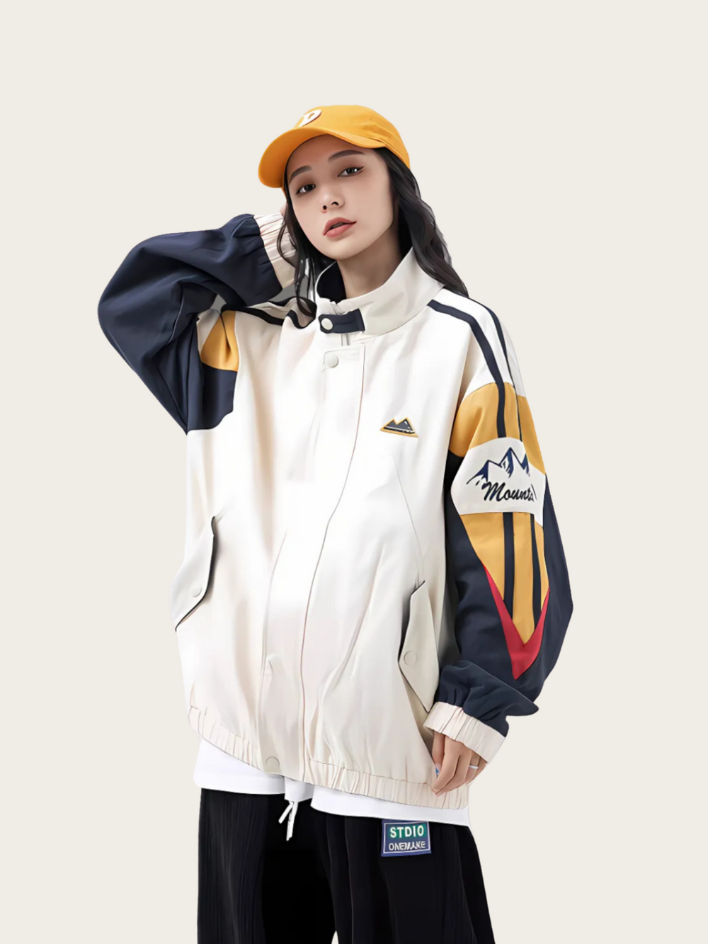 Person wearing a colorful jacket with a mountain logo on a plain background