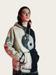Person wearing a hoodie with a unique design on a light background