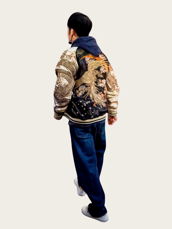 Person wearing a colorful jacket with intricate designs on a plain background