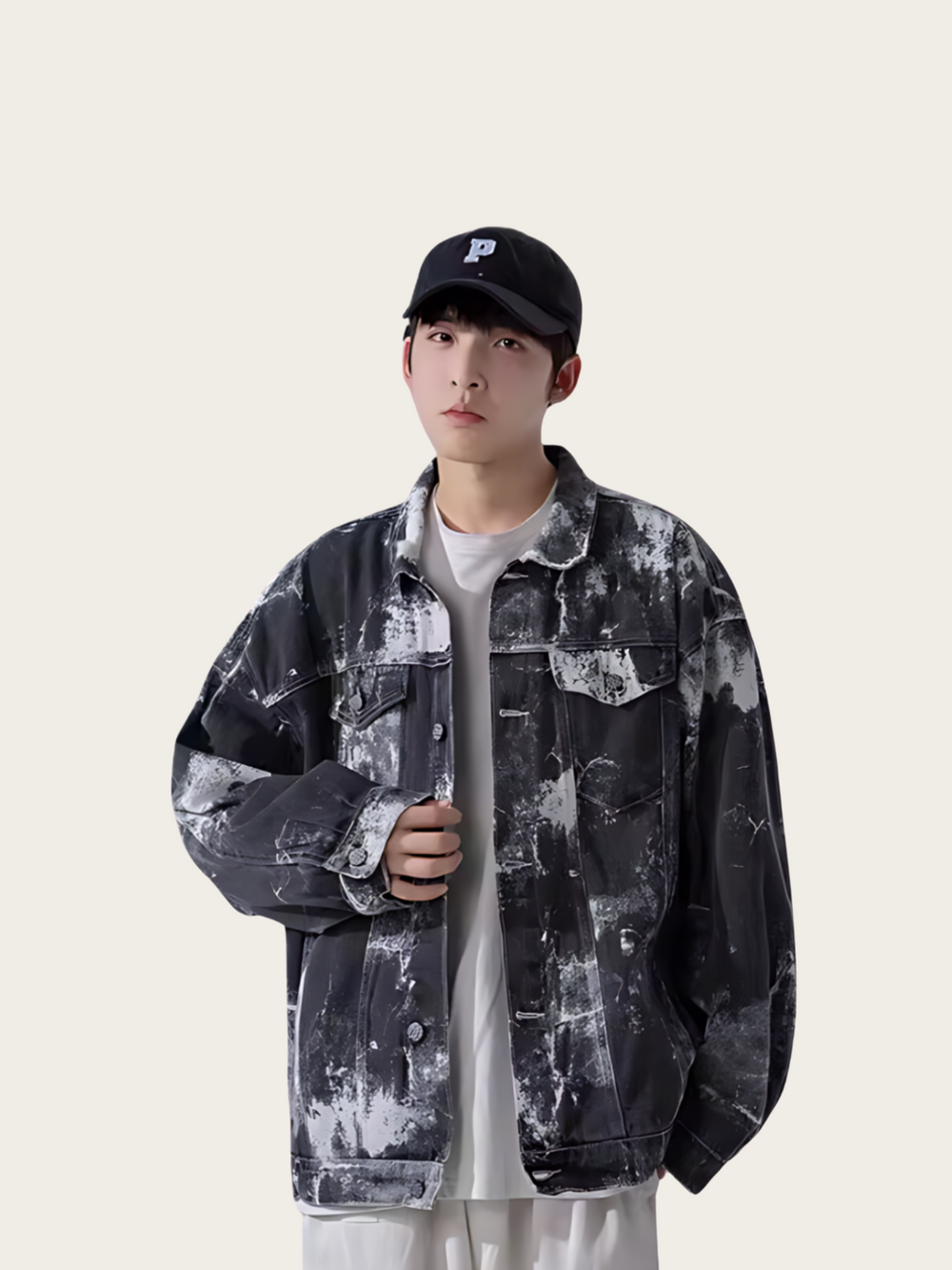 Person wearing a black and gray patterned jacket and cap on a white background