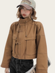 Person wearing a brown jacket and cap on a white background