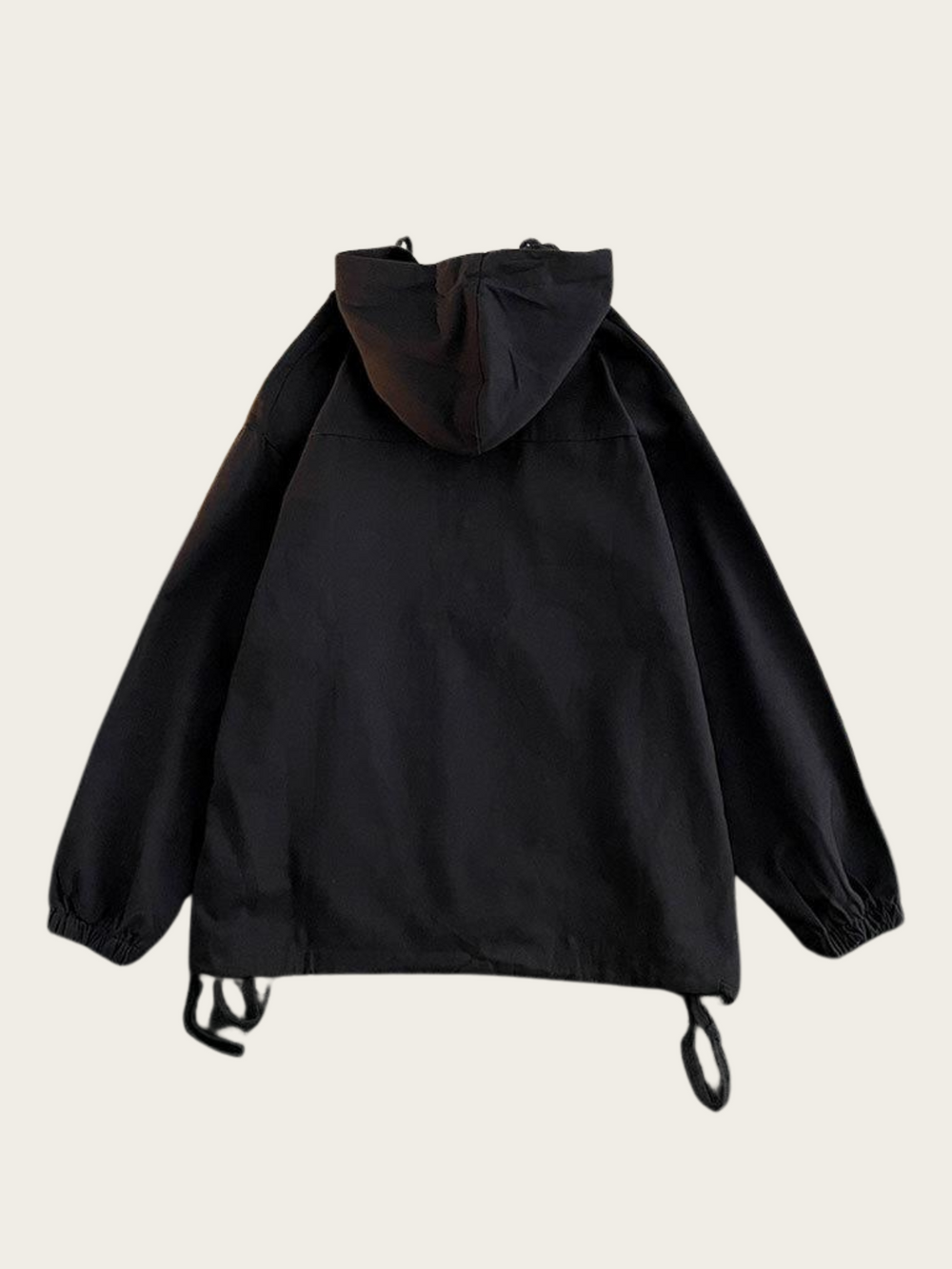 Black hooded jacket on a beige background