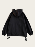 Black hooded jacket on a beige background